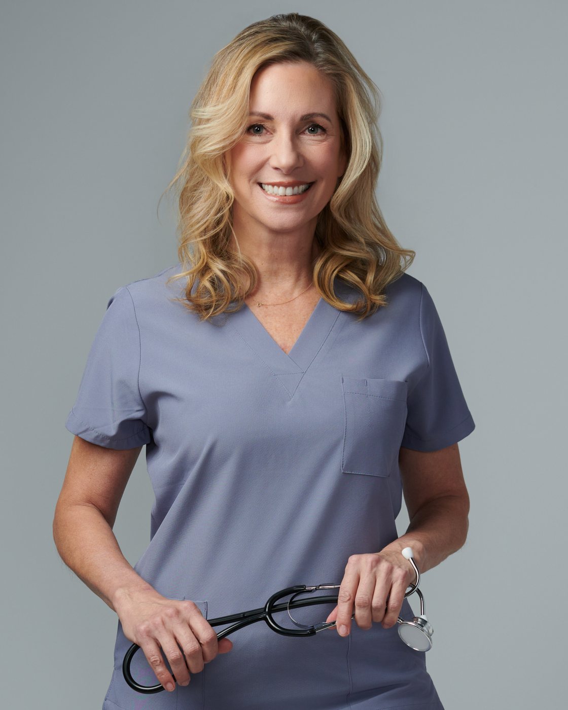 Dr. Stephanie Moore in scrubs with a stethoscope around her neck