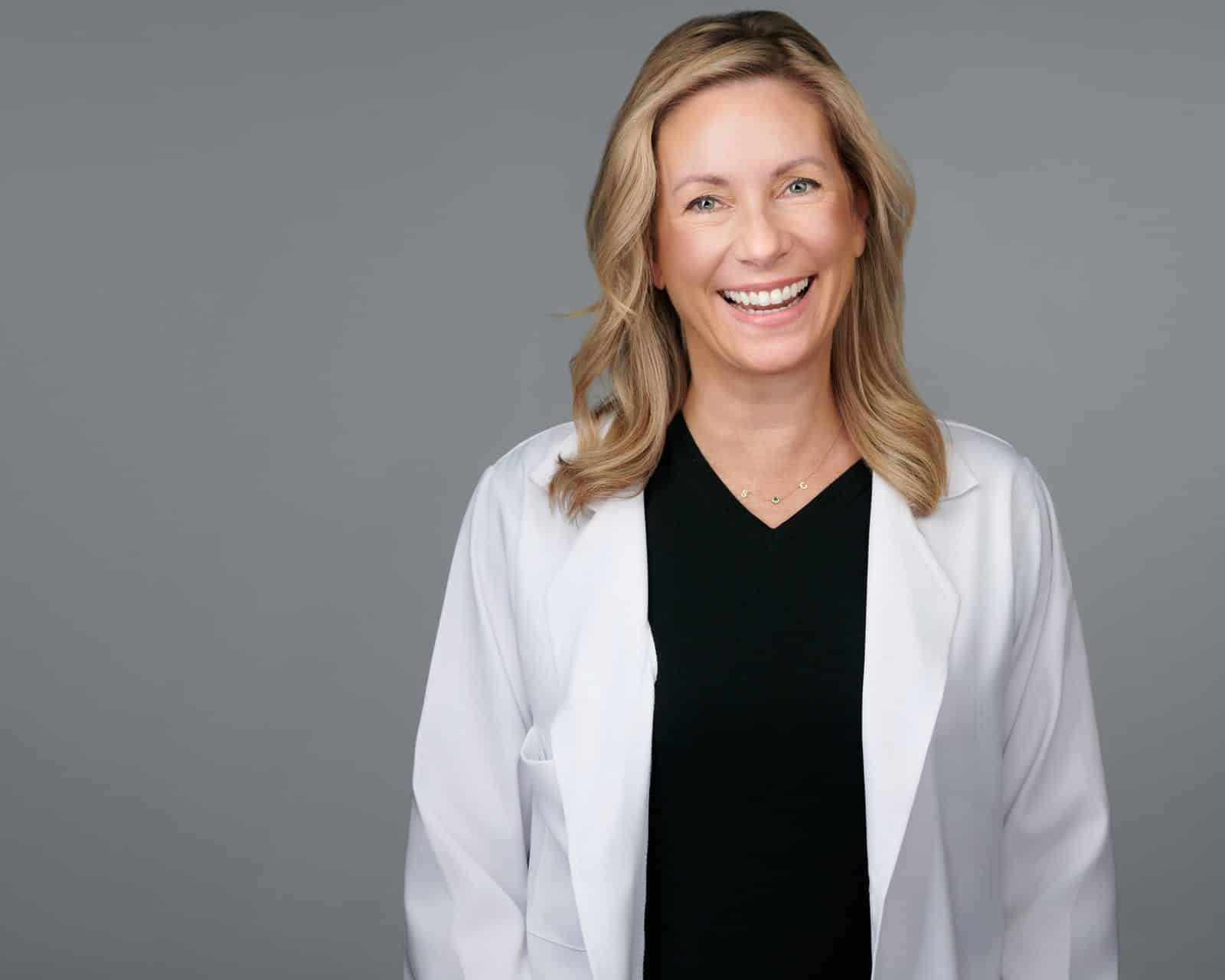 Dr. Stephanie Moore wearing a white coat over dark clothing
